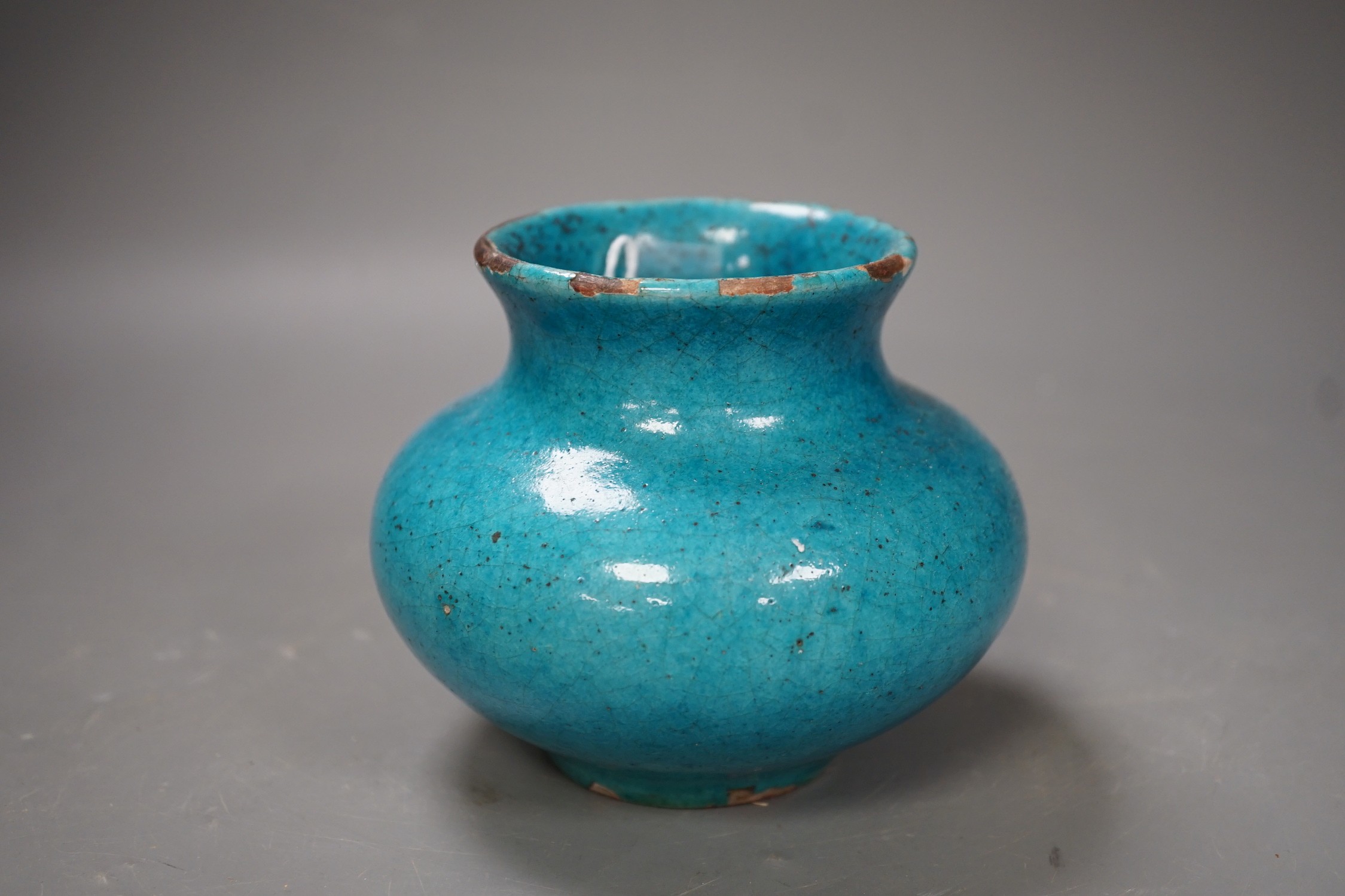 A Kashan style turquoise glazed vase. 10cm tall